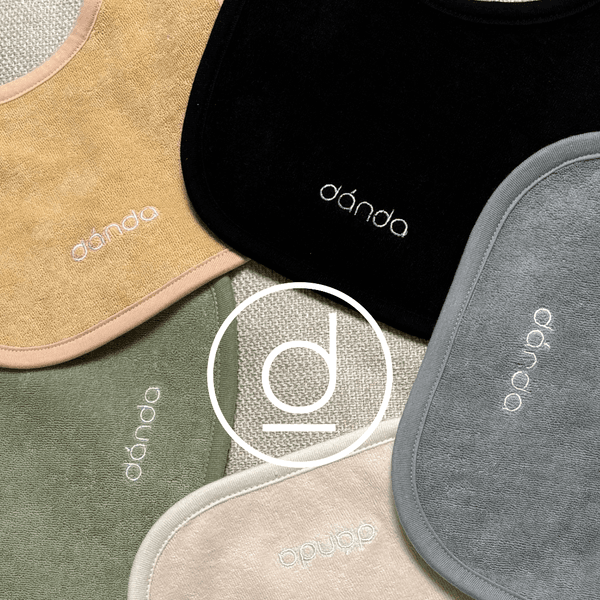 Colorful baby bibs arranged in a neat circle